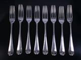 Eight Georgian silver table forks