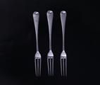Three silver dessert forks