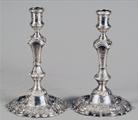 A matched pair of George II/III cast silver candlesticks