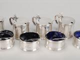 A set of four silver drum mustard pots and four salts en suite