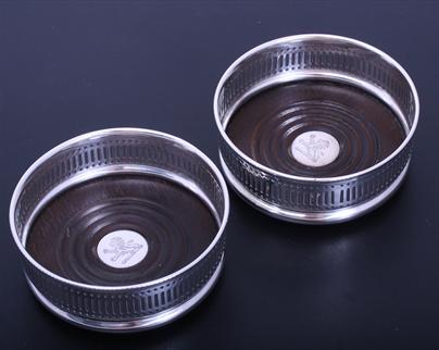 A pair of Edwardian electroplated bottle coasters