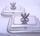 Pair Regency sterling silver entree dishes with armorial finials