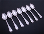 A set of seven Edwardian sterling silver Old English thread pattern dessert spoons