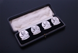 A charming set of four modern sterling silver armorial menu or card holders