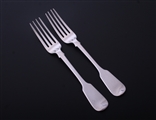A matched pair of George IV fiddle pattern sterling silver table forks