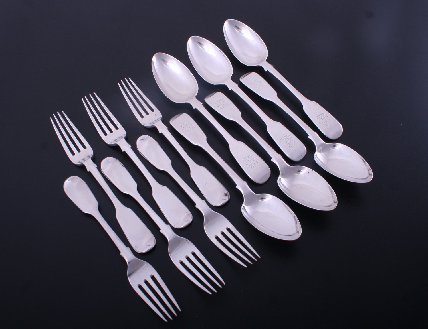 A set of Victorian fiddle pattern sterling silver dessert forks and spoons