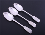 A matched set of three Victorian fiddle pattern sterling silver table spoons