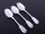 A matched set of three Victorian fiddle pattern sterling silver table spoons