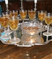 A set of cut glass armorial sherry glasses and a bowl