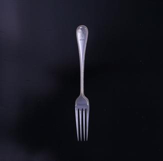An Edwardian Old English bead edge pattern sterling silver table fork