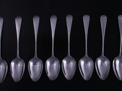 A set of eight Regency Old English pattern sterling silver dessert spoons
