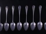 A set of eight Regency Old English pattern sterling silver dessert spoons