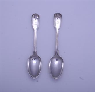 A pair of Victorian sterling silver fiddle thread and shell dessert spoons