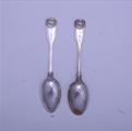 A pair of Victorian sterling silver fiddle thread and shell dessert spoons