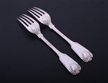 A pair of Victorian fiddle, thread and shell pattern sterling silver table forks