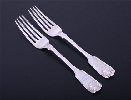 A pair of Victorian fiddle, thread and shell pattern sterling silver table forks