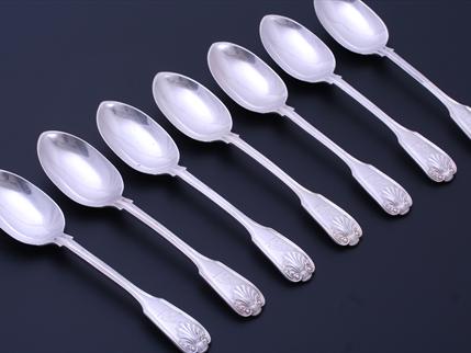 Set of seven Edwardian fiddle, thread and shell pattern sterling silver table spoons