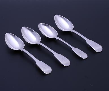 A set of four George IV fiddle pattern sterling silver dessert spoons