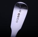 A set of four George IV fiddle pattern sterling silver dessert spoons