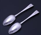 A rare pair of George III sterling silver Hanoverian pattern scrollback spoons