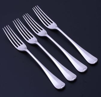 A set of four Edwardian Old English pattern sterling silver forks