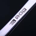 A sterling silver three pronged fork
