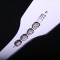 Three William IV sterling silver fiddle and husk pattern dessert spoons