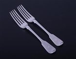 A pair of George IV sterling silver fiddle pattern table forks