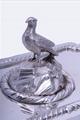 A William IV sterling silver entree dish and cover with armorial finial on electroplate two handled stand