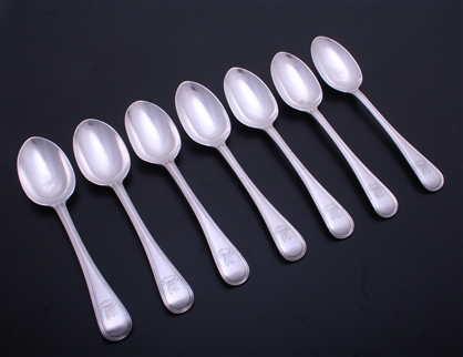 A set of seven Edwardian sterling silver Old English thread pattern dessert spoons