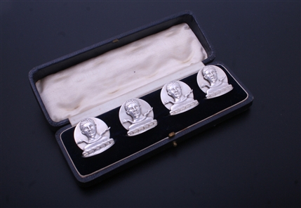 A charming set of four sterling silver armorial menu or card holders