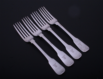 A set of four George III sterling silver fiddle pattern table forks
