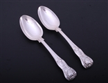 A pair of Victorian Hourglass pattern sterling silver dessert spoons