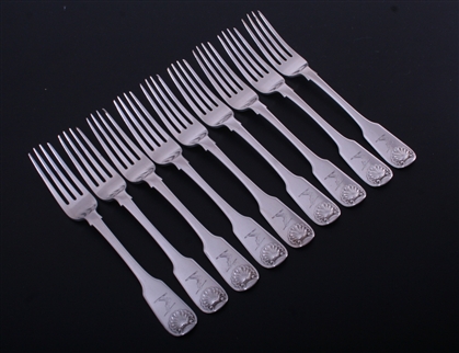 A set of eight George IV fiddle and shell pattern sterling silver table forks