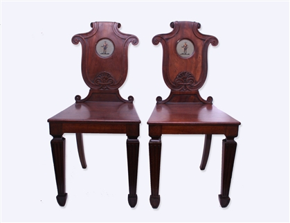 A good pair of George IV mahogany armorial hall chairs attributed to T & G Seddon