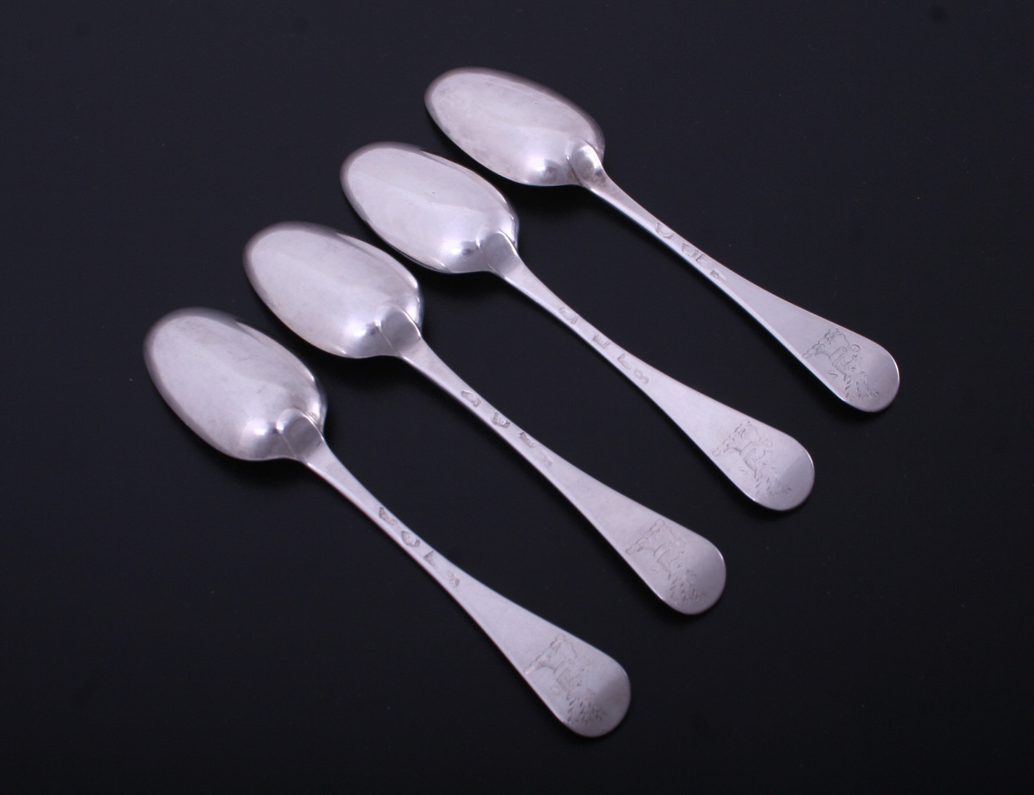 A set of four Hanoverian pattern sterling silver dessert spoons