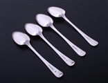 A matched set of four George III Old English pattern sterling silver dessert spoons