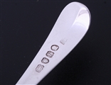 A matched set of four George III Old English pattern sterling silver dessert spoons