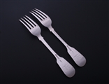 A matched pair of George IV fiddle pattern sterling silver table forks