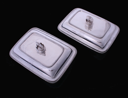 A fine pair of George III sterling silver entree dishes with armorial finials