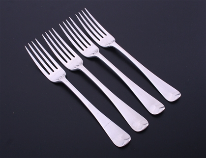 A set of four George III Old English pattern sterling silver table forks