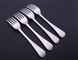 A set of four George III Old English pattern sterling silver table forks