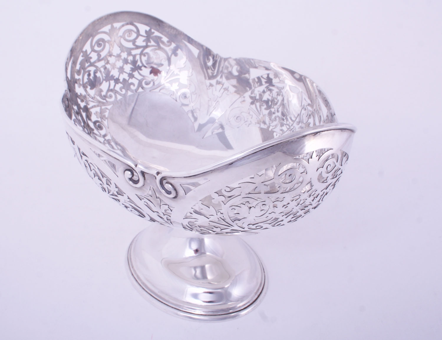 An impressive set of three Edwardian sterling silver fruit baskets