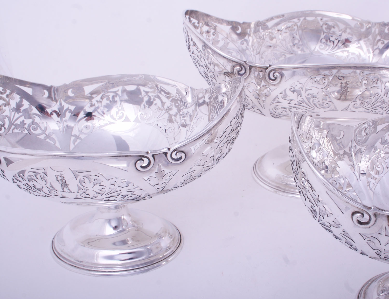 An impressive set of three Edwardian sterling silver fruit baskets