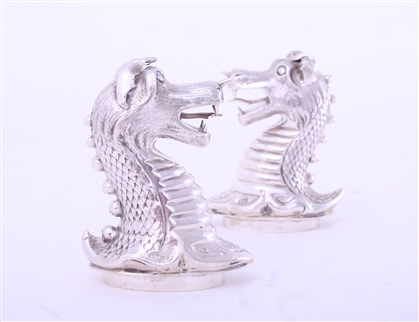 A rare pair of Victorian sterling silver heraldic novelty pepper casters