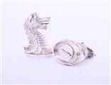 A rare pair of Victorian sterling silver heraldic novelty pepper casters