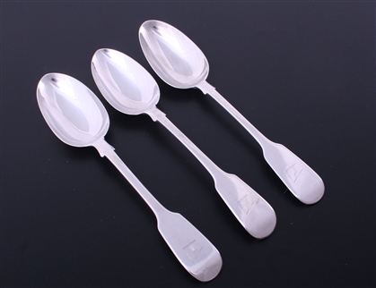 A matched set of three Victorian fiddle pattern sterling silver table spoons