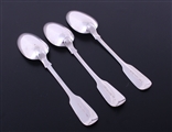 A matched set of three Victorian fiddle pattern sterling silver table spoons