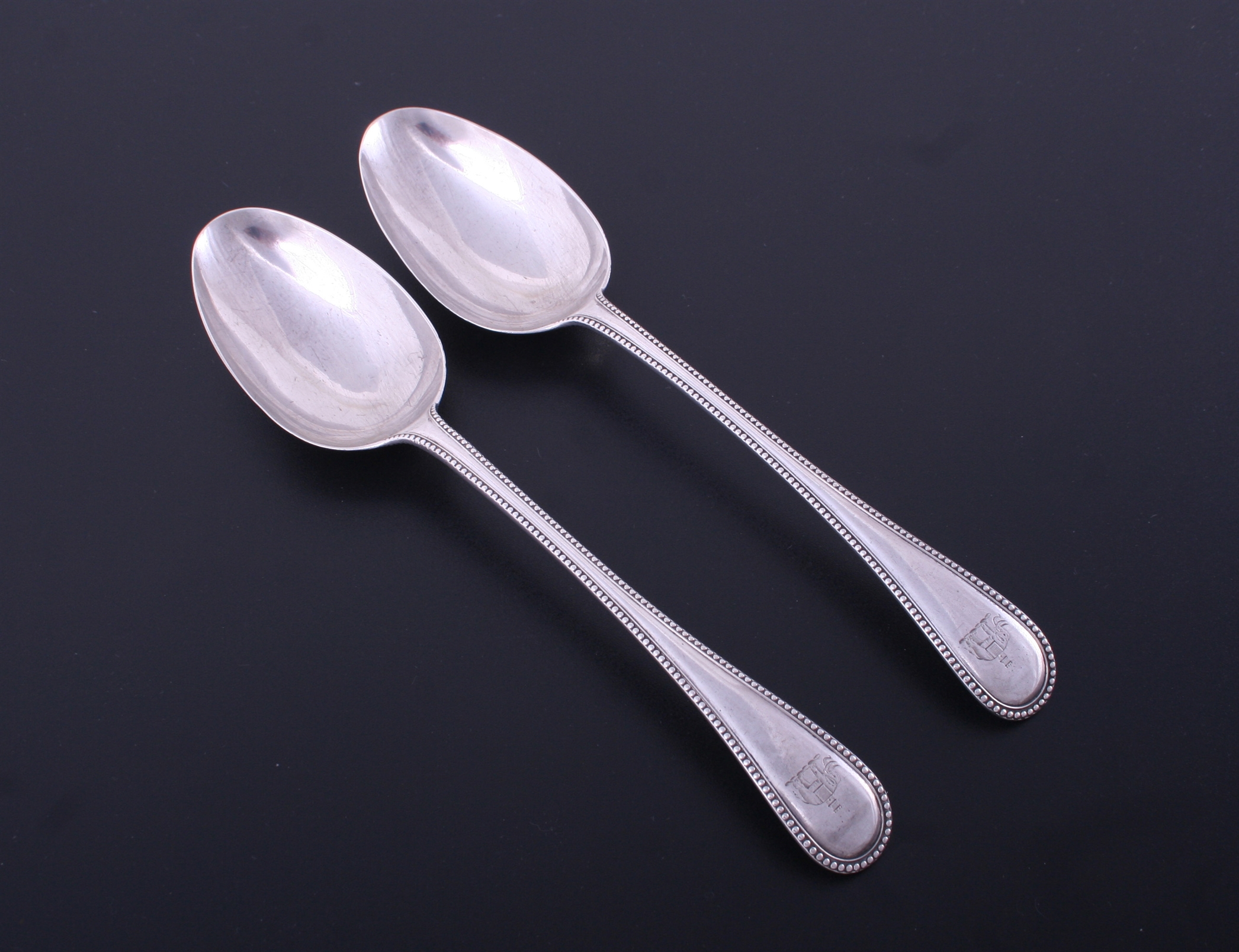 A pair of Victorian Old English bead edge sterling silver table spoons