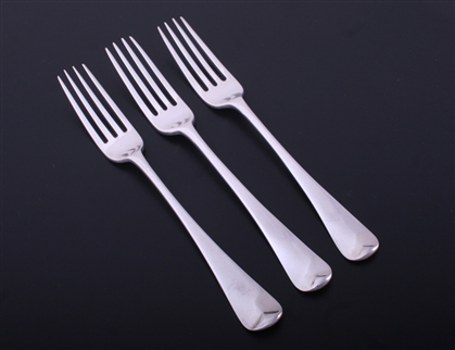 A set of three George III Old English pattern sterling silver table forks